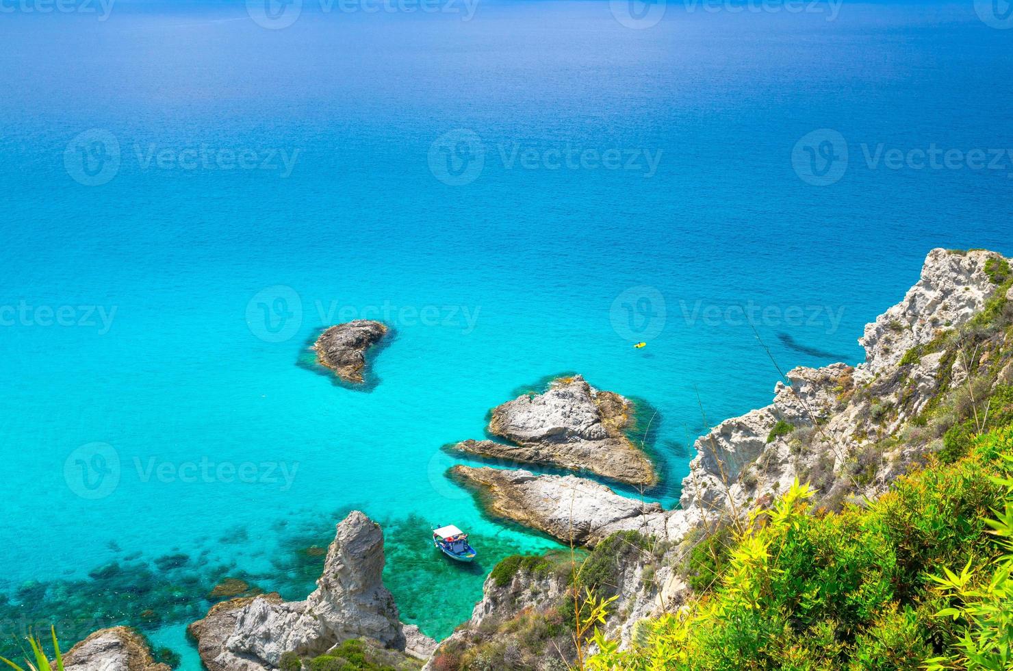 Fishing yacht and rubber boat in Capo Vaticano lagoon, Calabria, Italy photo