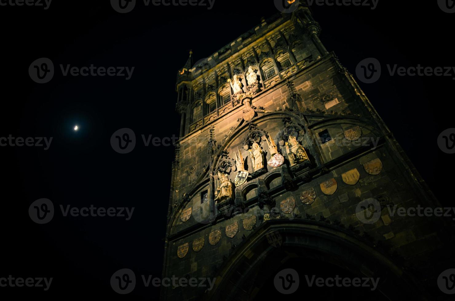 Crescent moon in evening sky over night Prague Old Town Bridge Tower photo