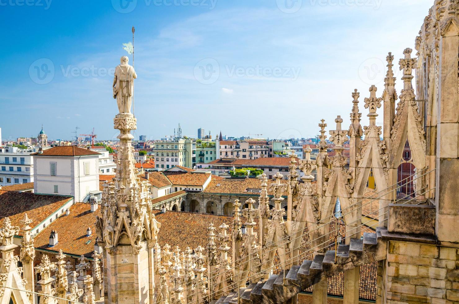 White marble statues on roof of Duomo di Milano Cathedral, Italy photo
