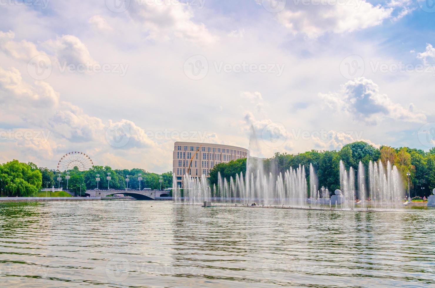 Minsk cityscape with fountain in Svislach or Svislac river, Janka Kupala Park green trees photo