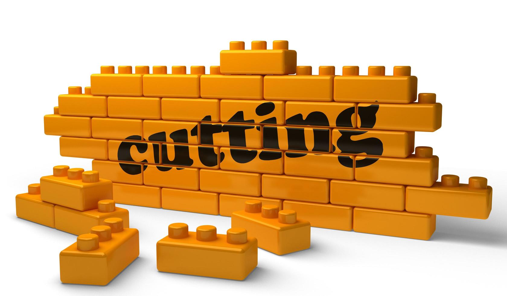 cutting word on yellow brick wall photo