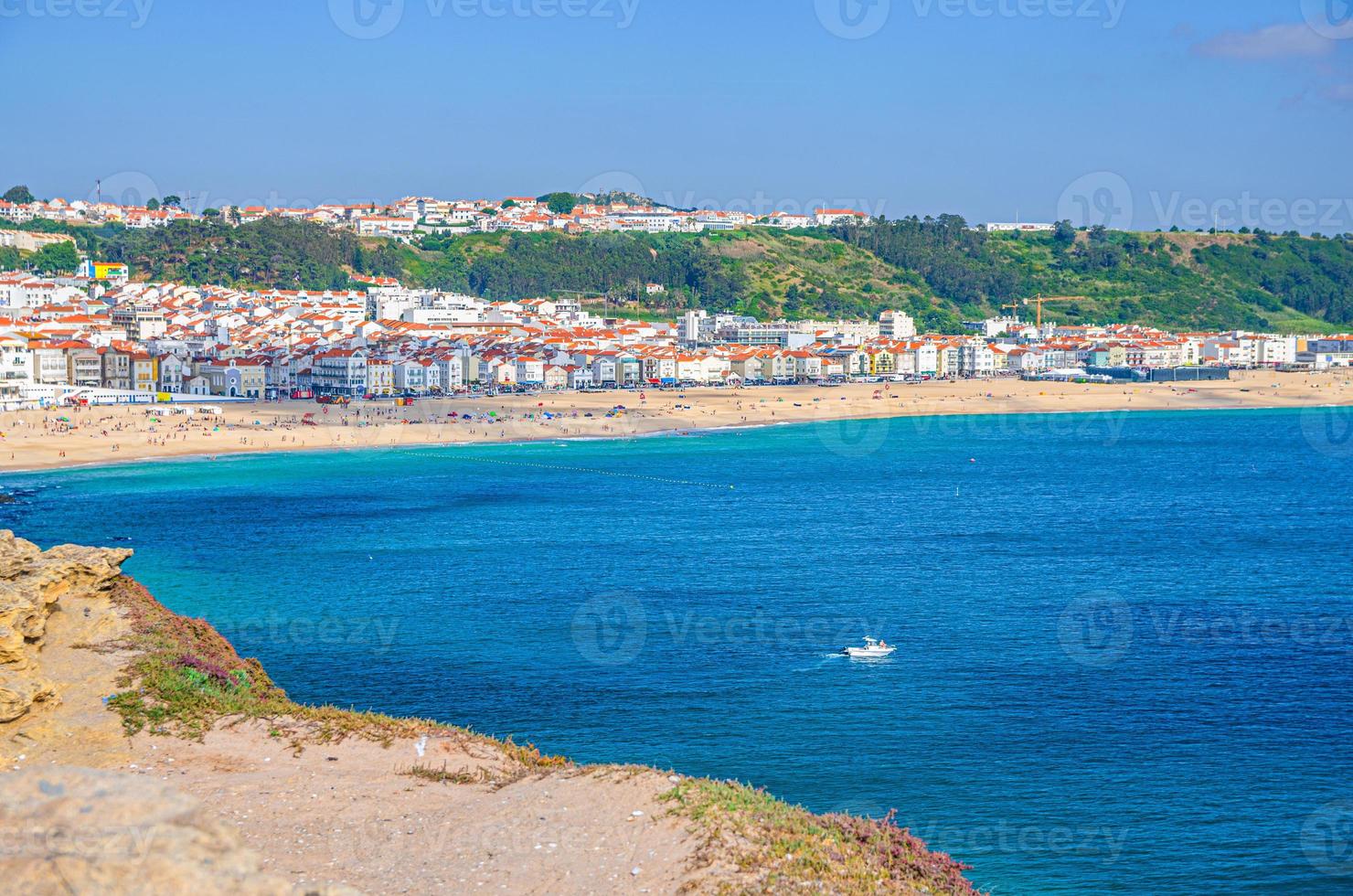 Aerial view of rocks and cliffs, azure turquoise water of Atlantic Ocean and sandy beach coastline Praia da Nazare photo