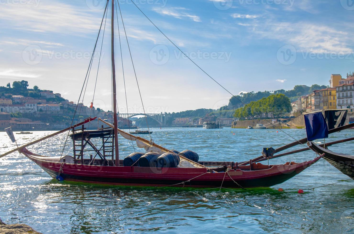Portugal, city landscape Porto, wooden boats with wine port barrels close up on Douro river photo