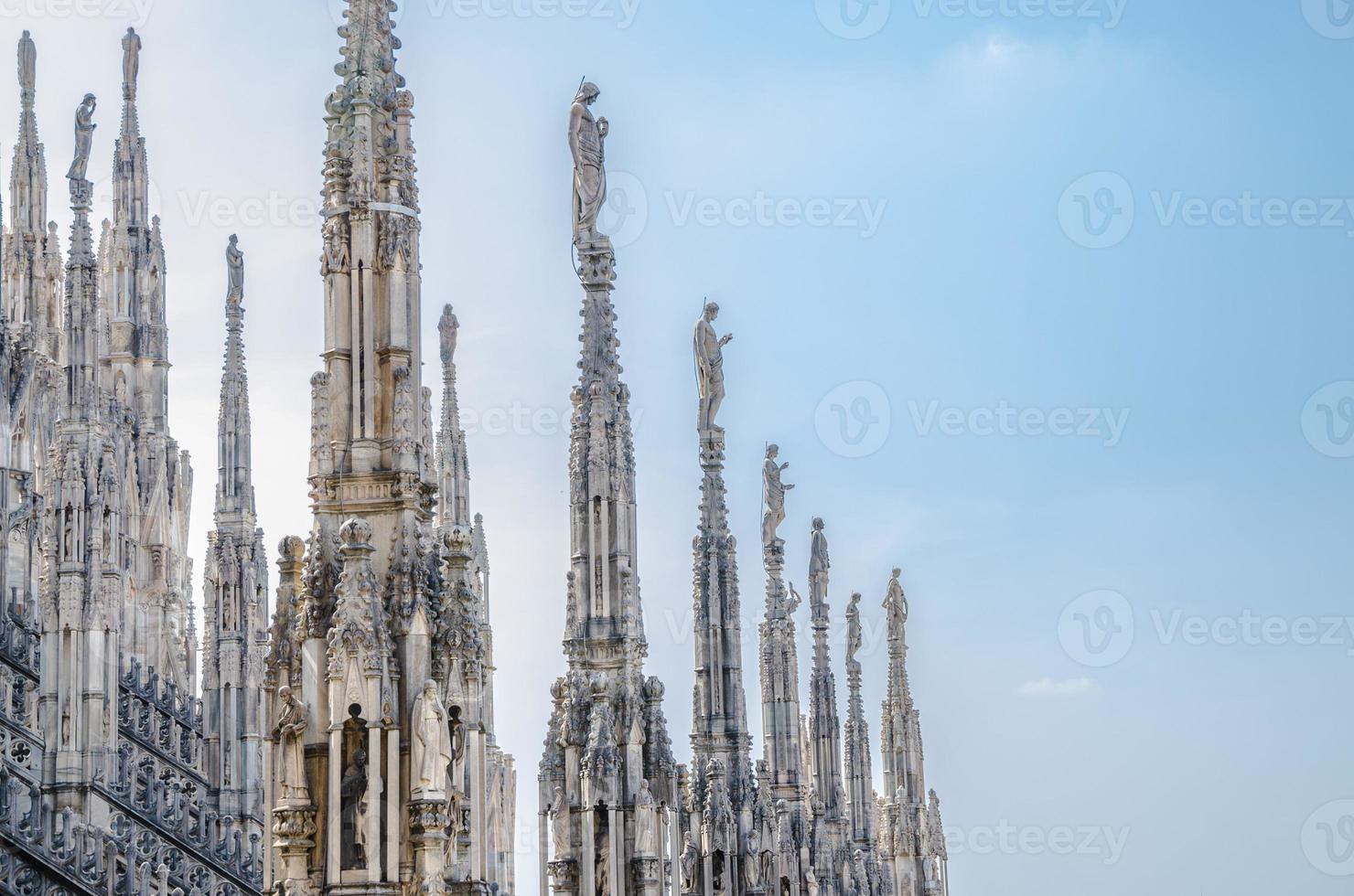 White marble statues on roof of Duomo di Milano Cathedral, Italy photo