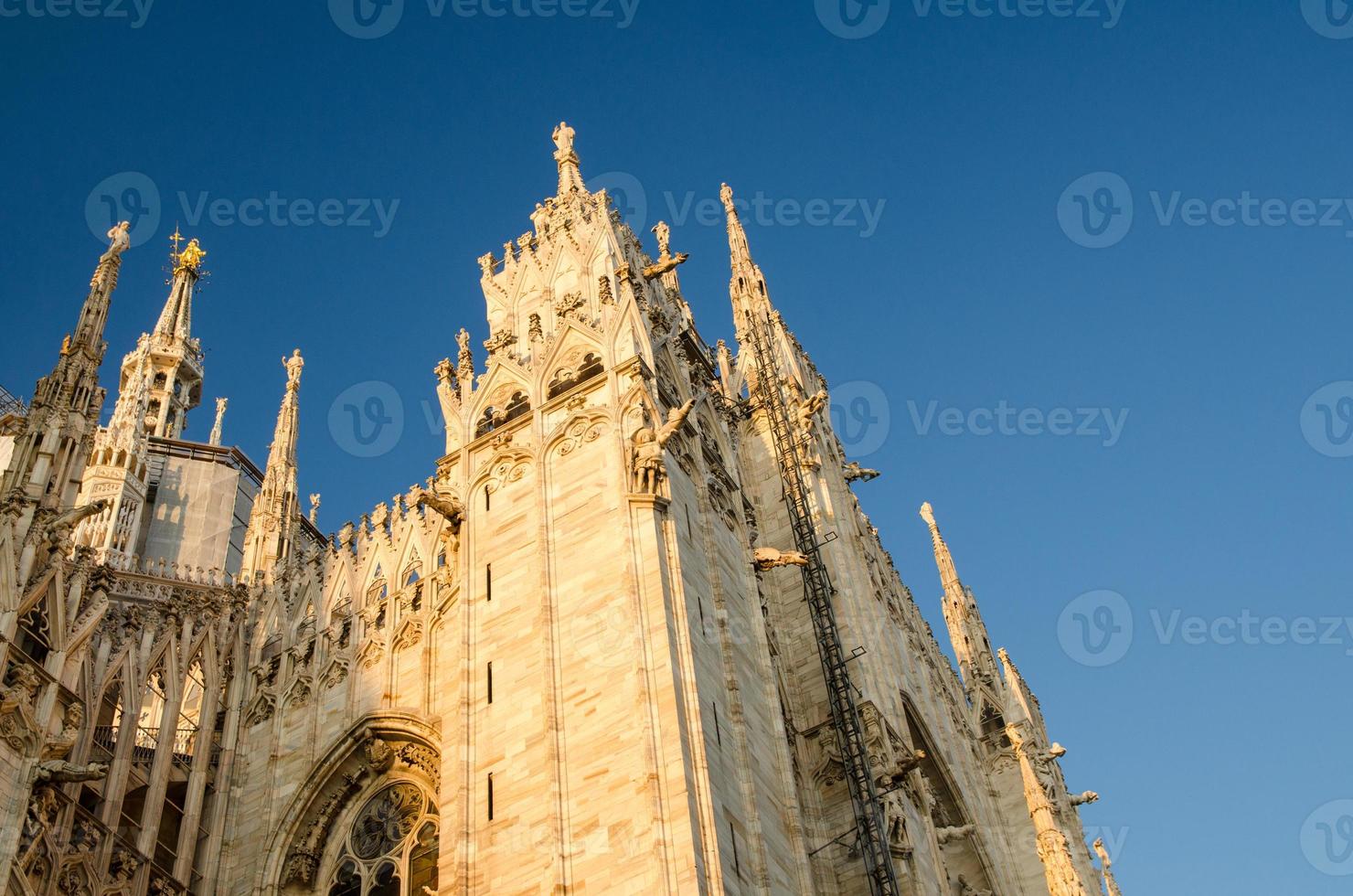 White walls of Duomo di Milano cathedral with high windows, Italy photo