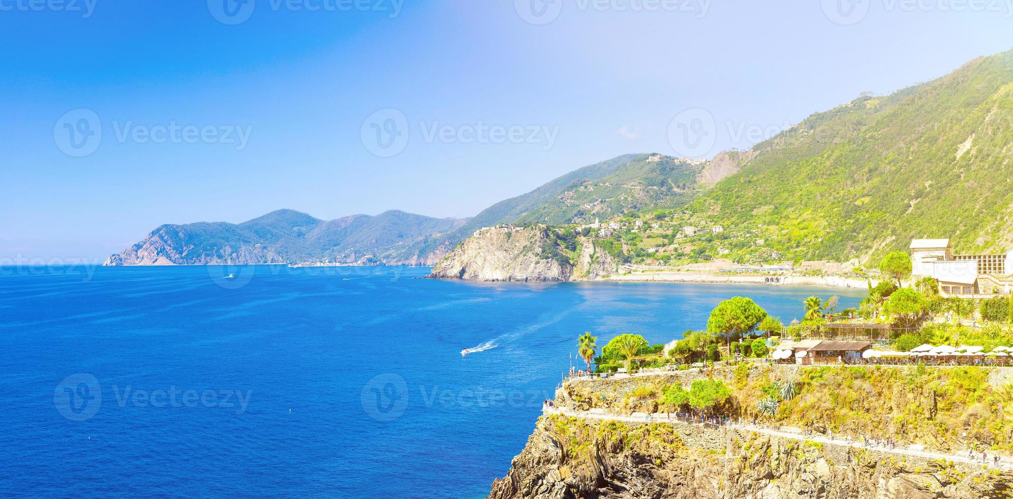 Aerial top view of white yacht sail on water of Ligurian Sea near coastline of Riviera di Levante photo