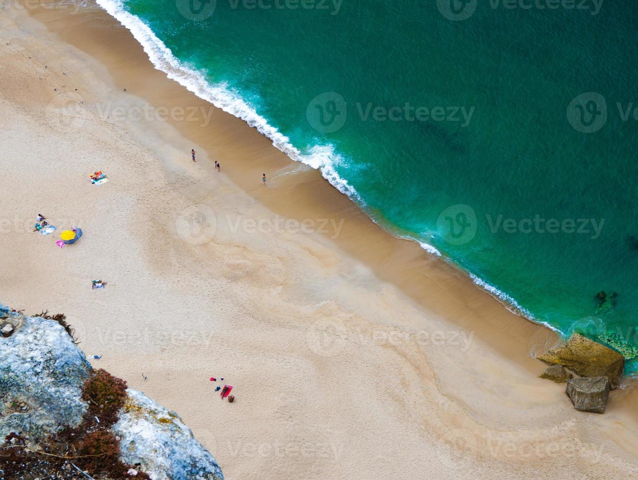 Portugal, Nazare coastline view, white sand of beaches of Portugal, stone cliffs above the ocean photo