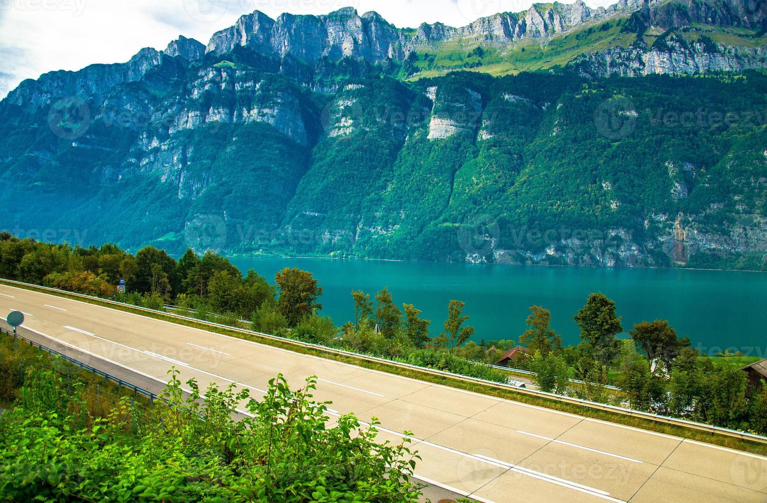 Village house near Lake Walensee and mountain chain, Switzerland photo