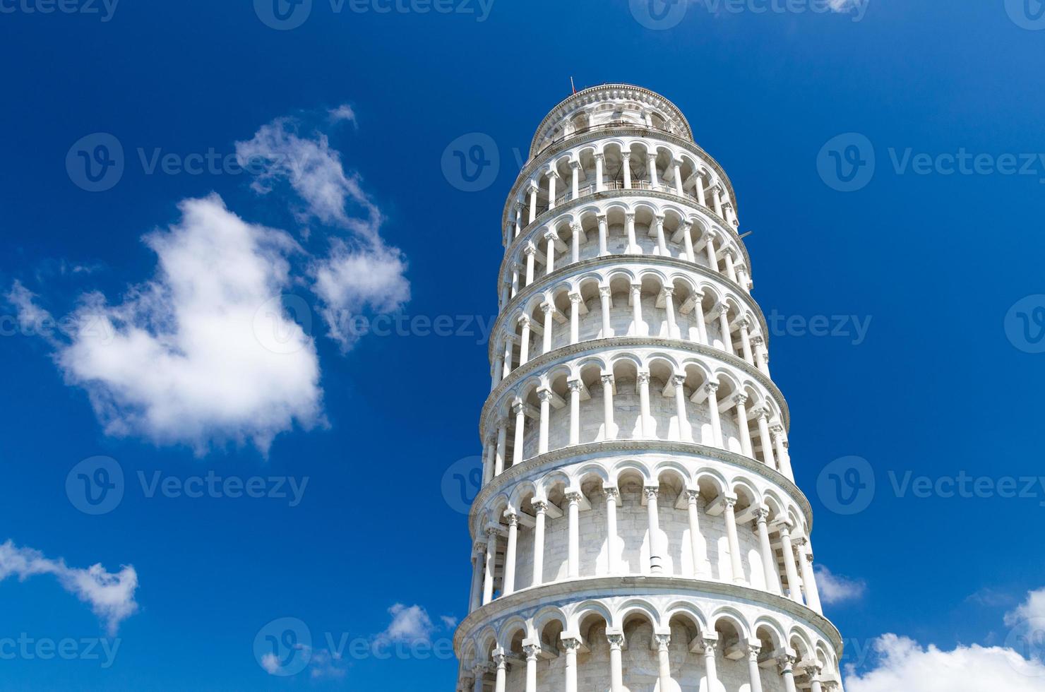 Leaning Tower Torre di Pisa on Piazza del Miracoli square, blue sky with white clouds background photo