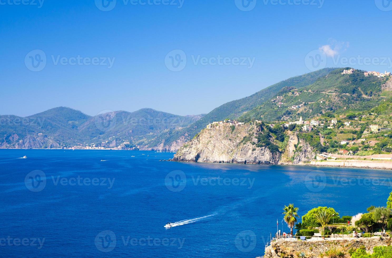 Aerial top view of white yacht sail on water of Ligurian Sea near coastline of Riviera di Levante photo