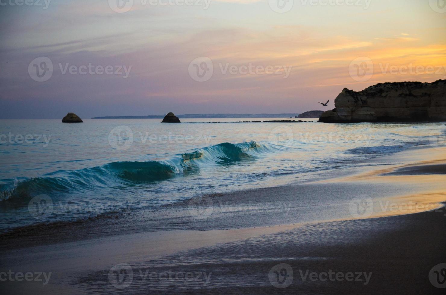 Portugal, Algarve, The best beaches of Portimao, Praia da Rocha, sunset over The Atlantic Ocean photo