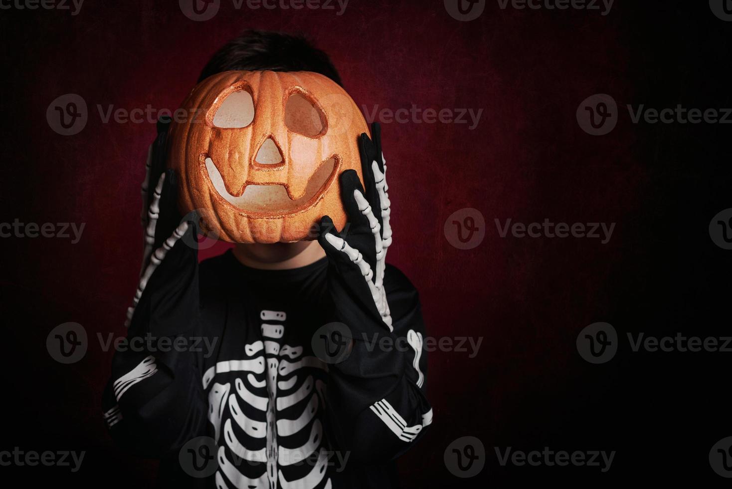 boy in skeleton costume on halloween photo