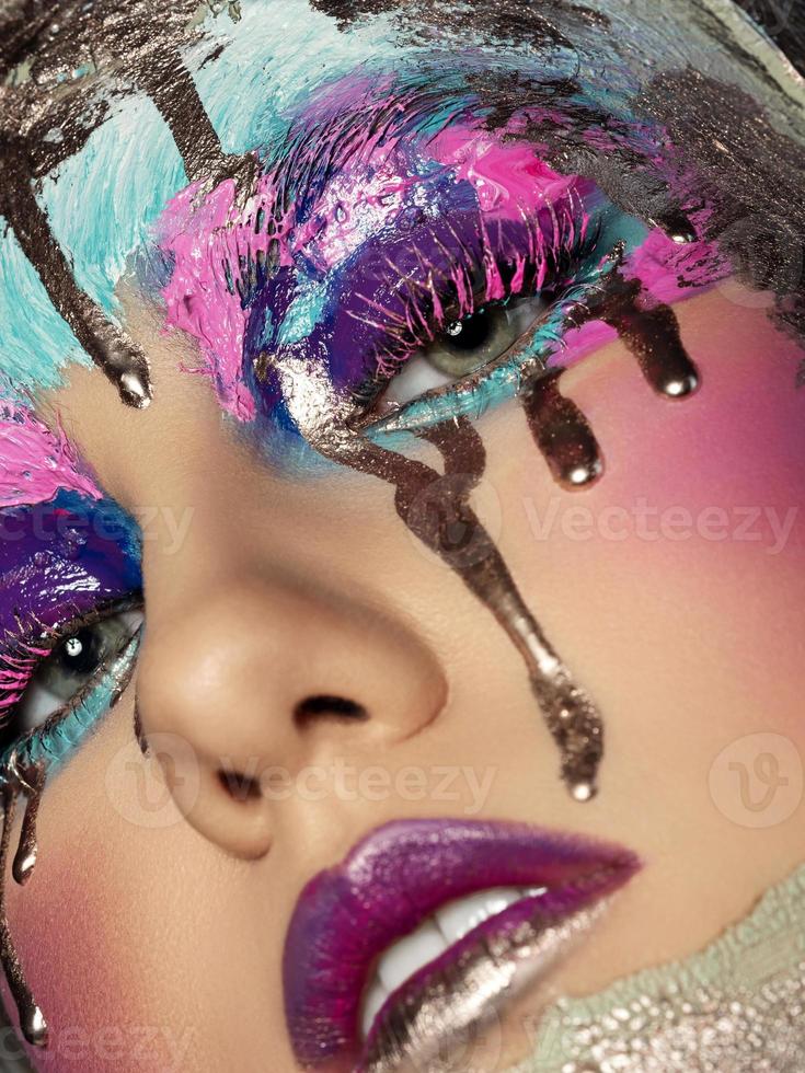 Closeup view of woman face with creative makeup photo