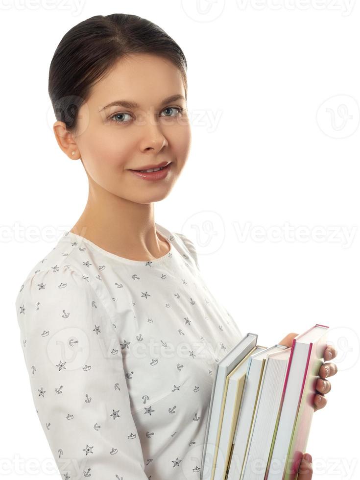 Smiling woman with a stack of books photo