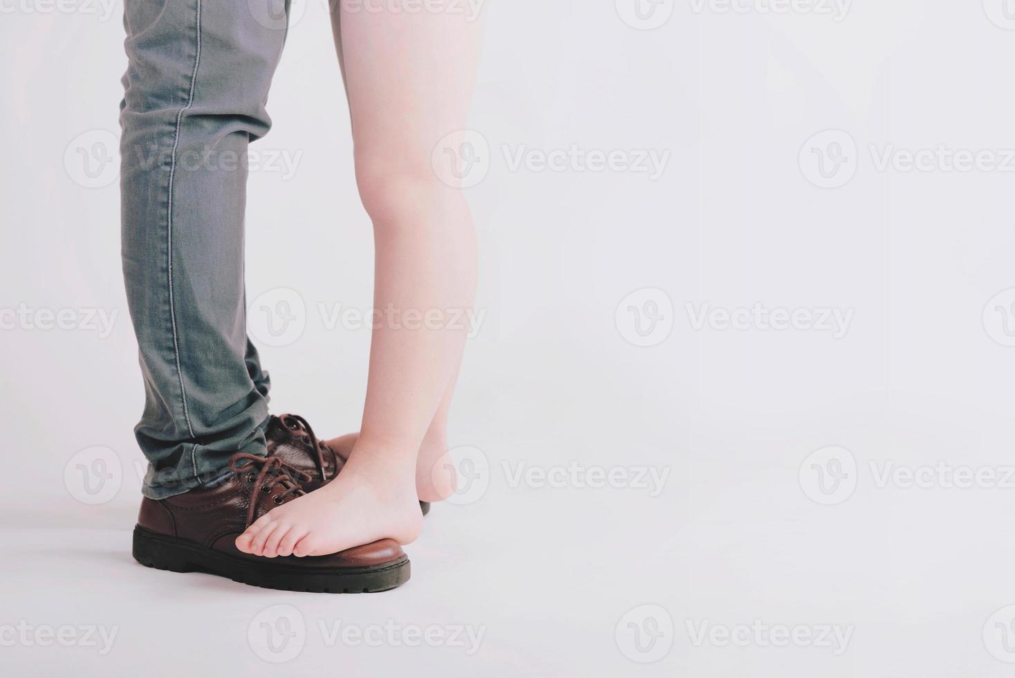 They are standing on father's feet photo