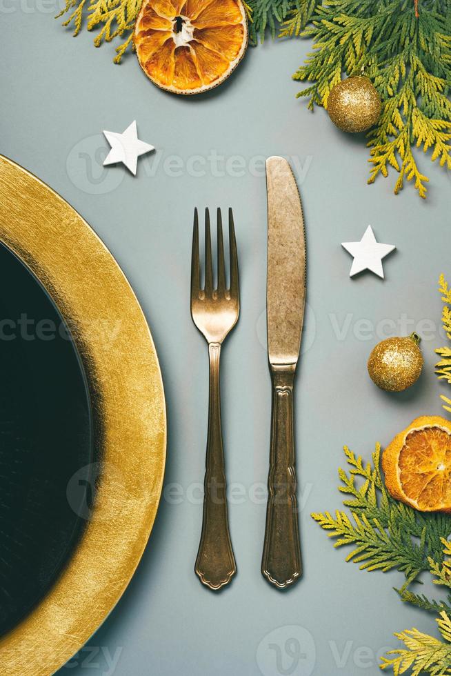 Christmas concept background. Vintage old cutlery, plate for Christmas Dinner and christmas ornament. Christmas dinner concept photo