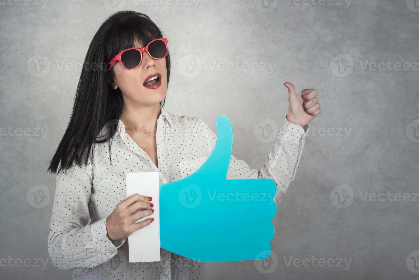 Young Woman holding a like icon photo