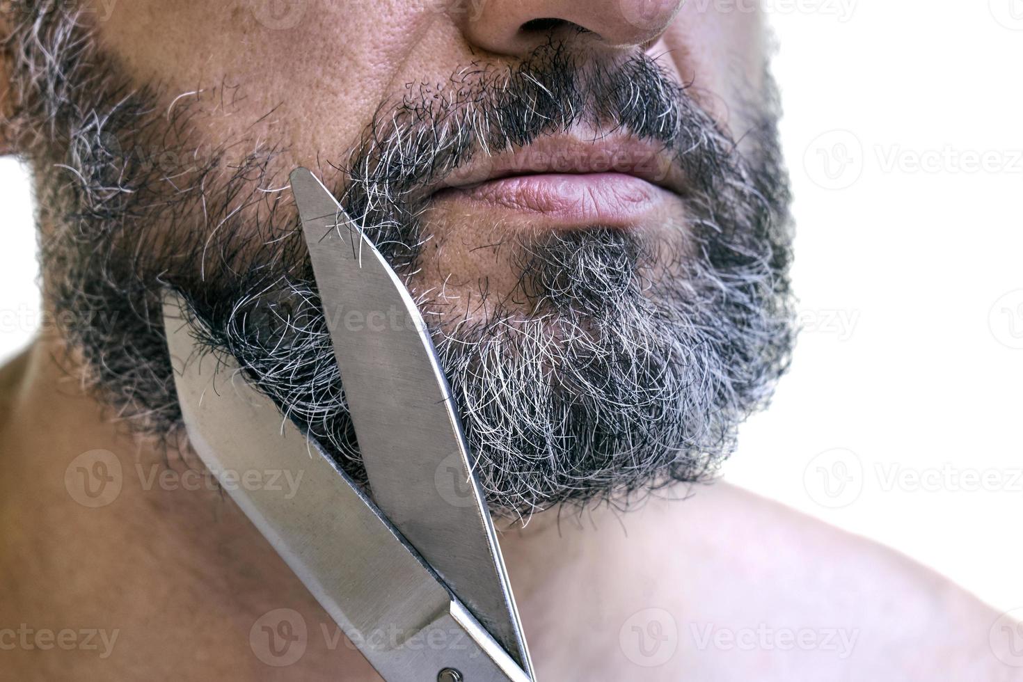 Beard cutting using big old scissors photo