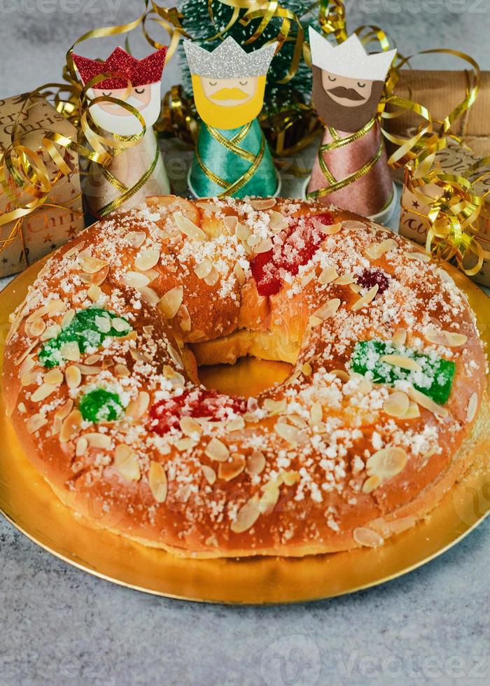 Roscon de reyes with cream and christmas ornaments. Kings day concept spanish three kings cake.Typical spanish dessert for Christmas. Selective focus photo