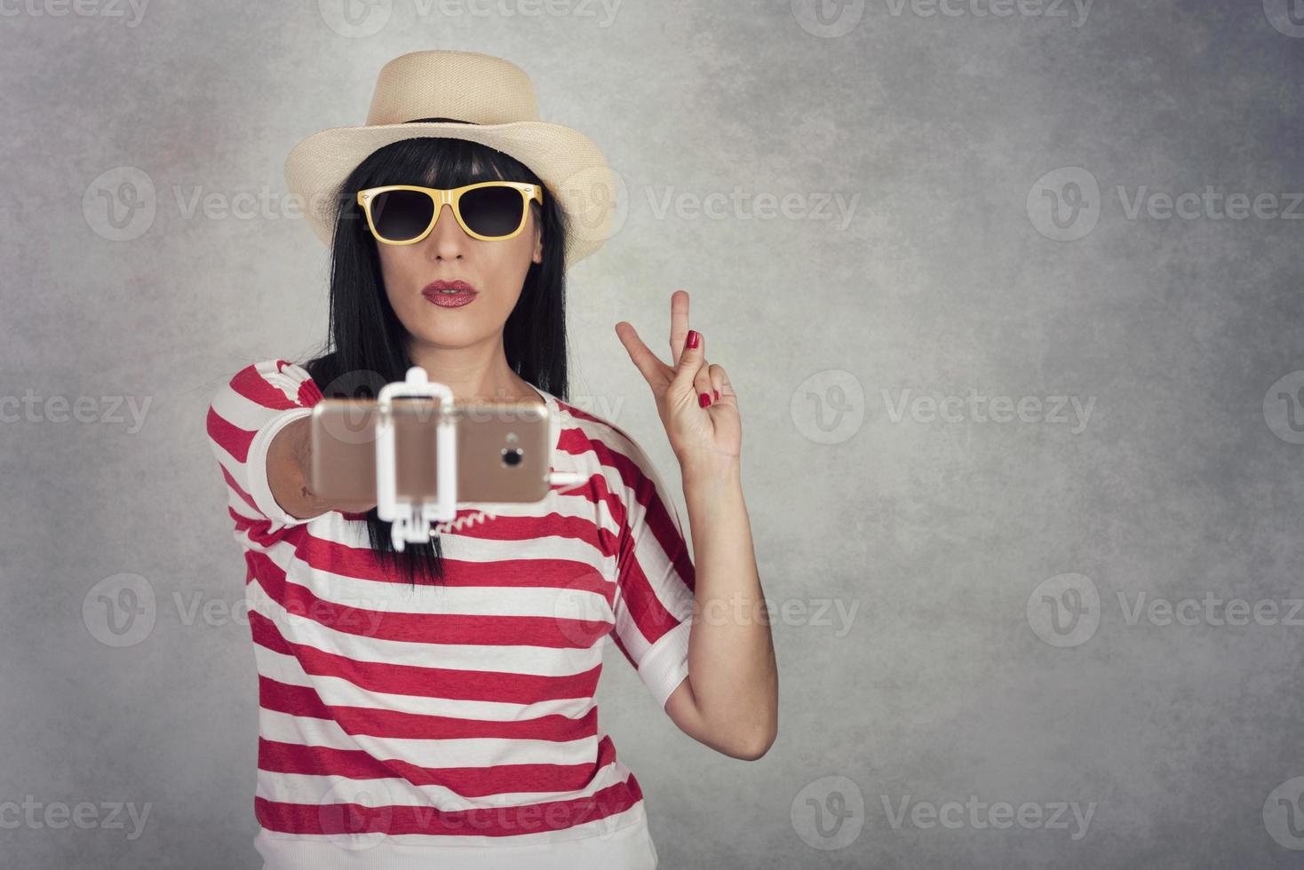 Young woman smiling taking a selfie photo