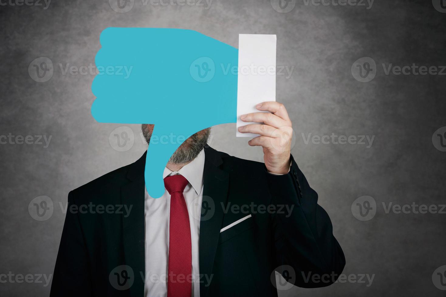 Businessman holding a dislike icon photo