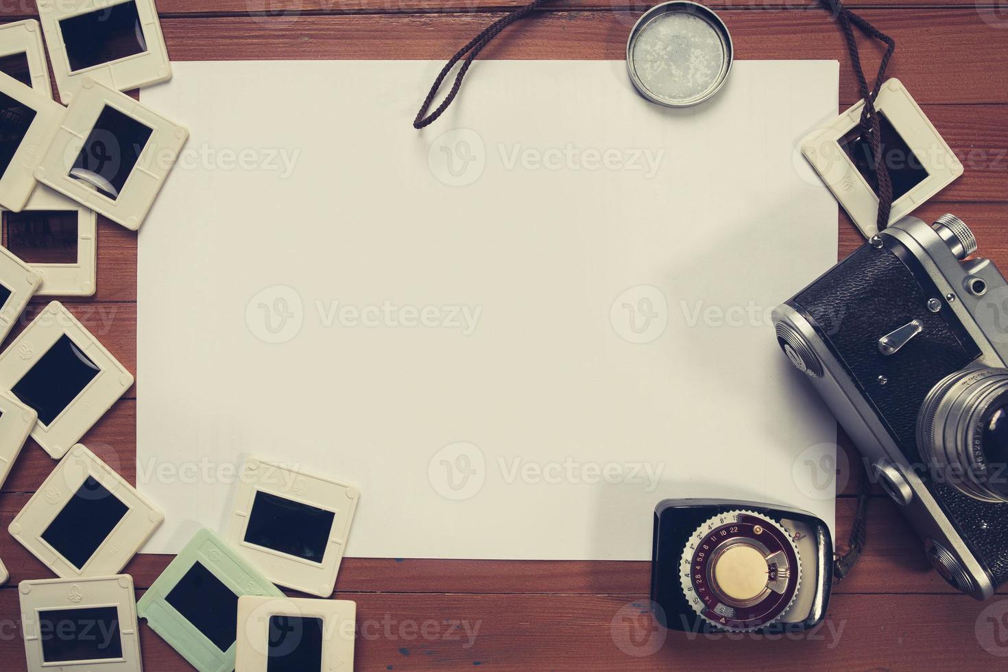 retro camera and some old photos on wooden table