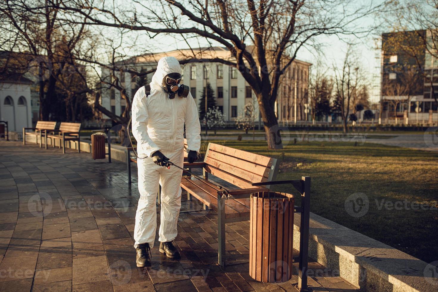 Cleaning and Disinfection on the playground in the sity complex amid the coronavirus epidemic Teams for disinfection efforts Infection prevention and control of epidemic Protective suit and mask photo