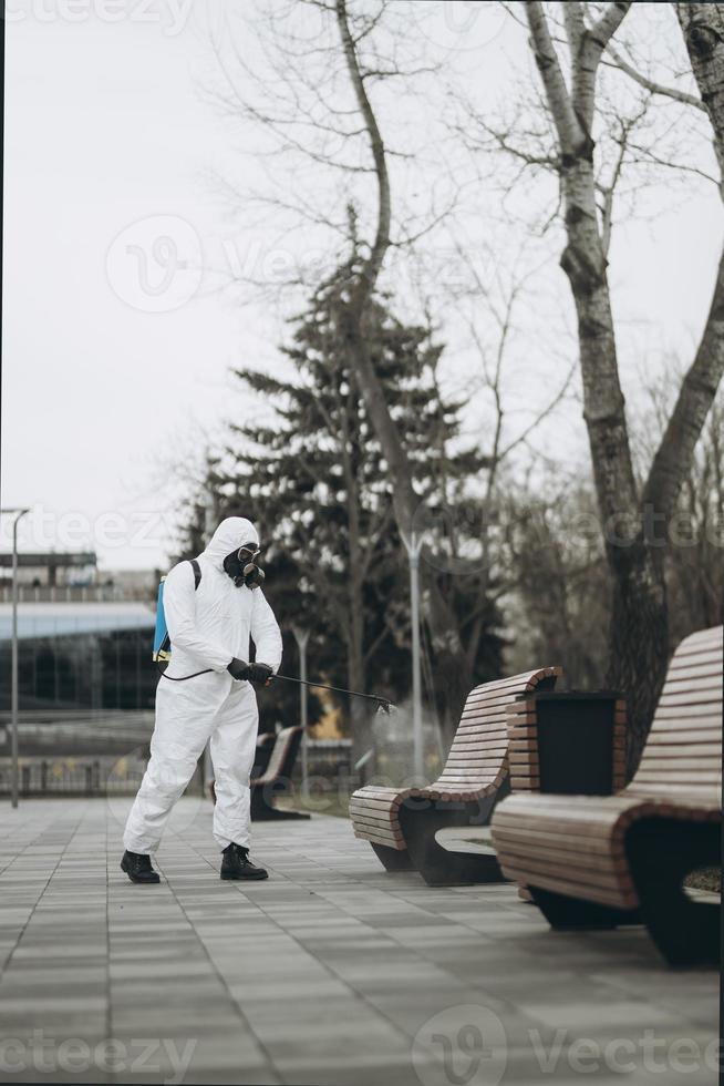 Cleaning and Disinfection at town complex amid the coronavirus epidemic Professional teams for disinfection efforts Infection prevention and control of epidemic Protective suit and mask photo
