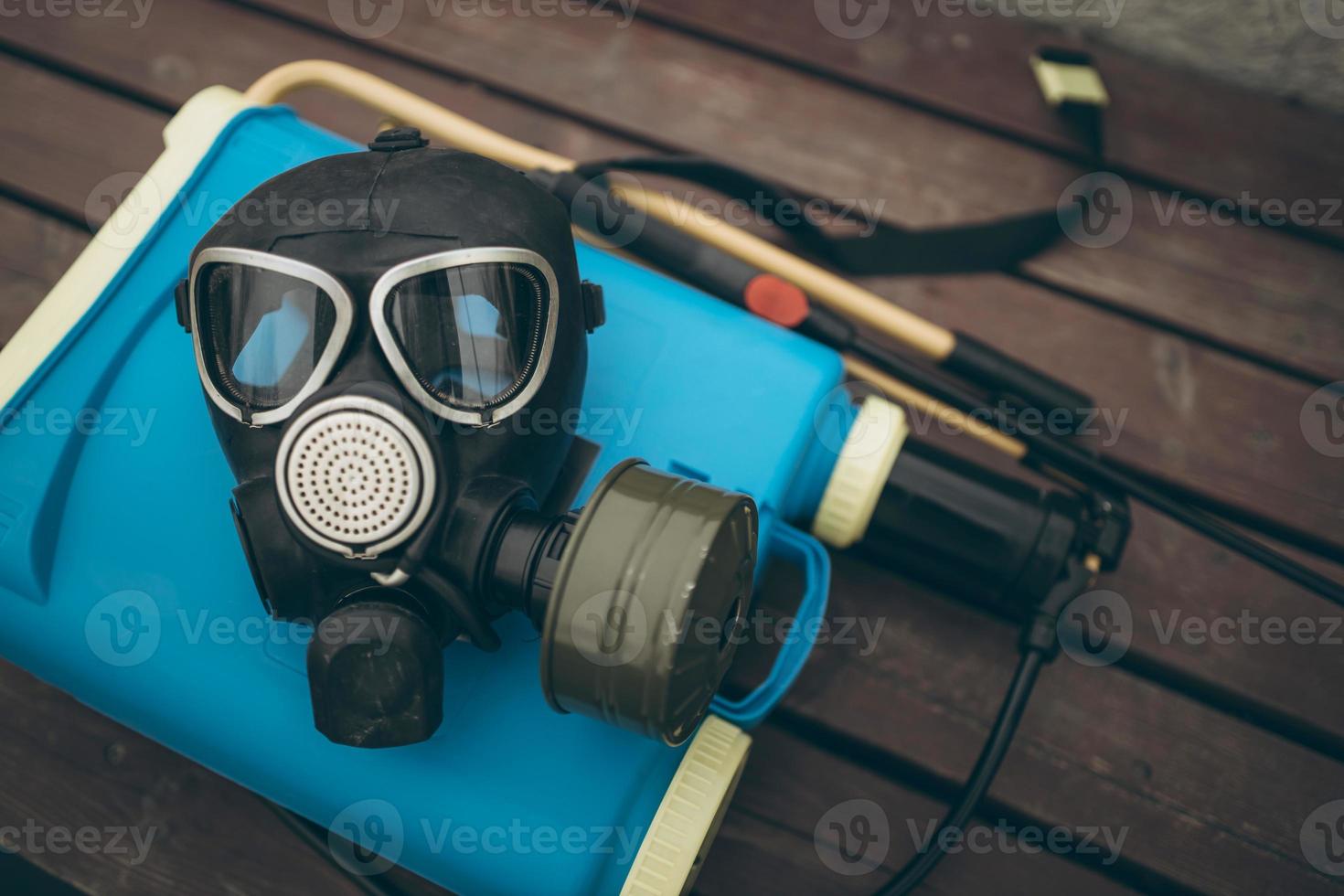 A protective mask and knapsack for disinfection lie on a bench in the urban complex Protection and prevention of the coronavirus epidemic photo