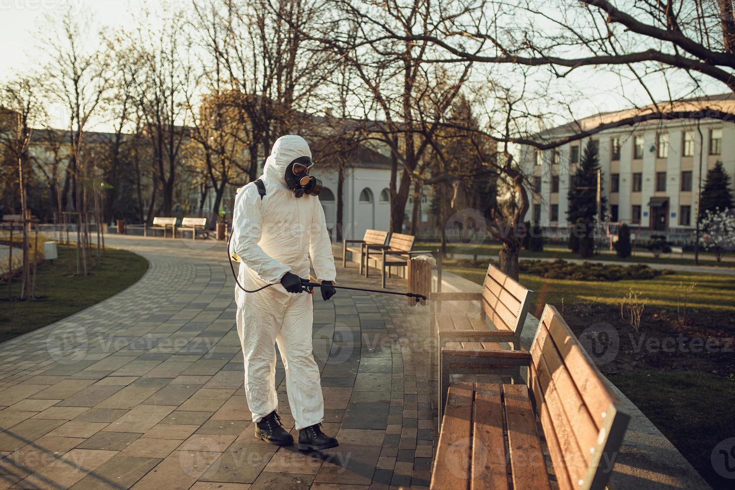 Cleaning and Disinfection on the playground in the sity complex amid the coronavirus epidemic Teams for disinfection efforts Infection prevention and control of epidemic Protective suit and mask photo