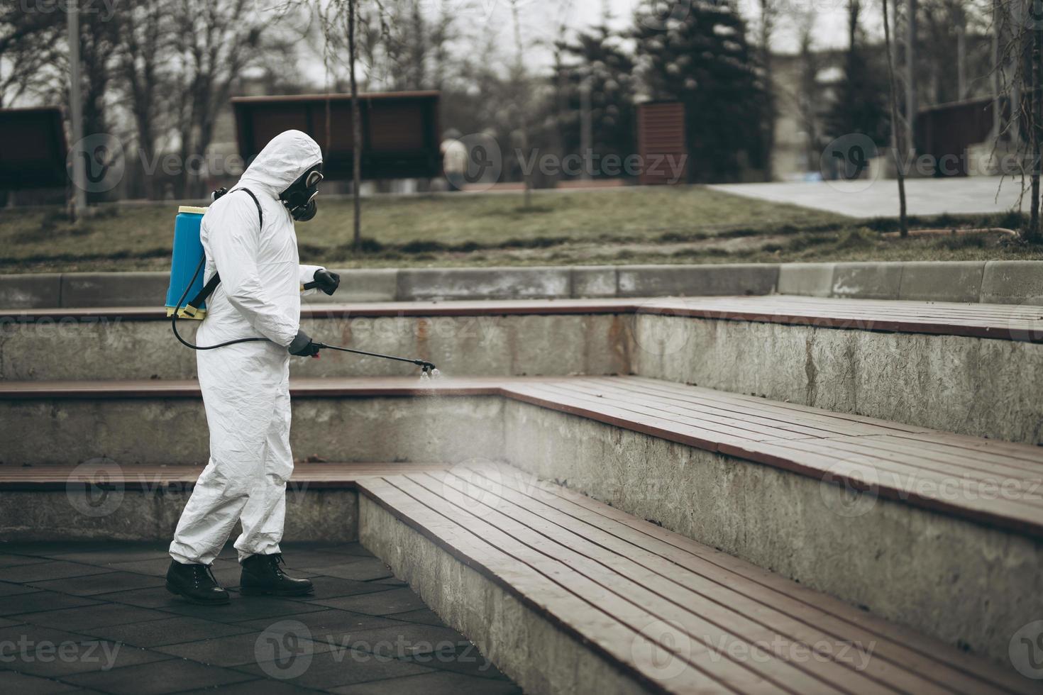 Cleaning and Disinfection at town complex amid the coronavirus epidemic Professional teams for disinfection efforts Infection prevention and control of epidemic Protective suit and mask photo