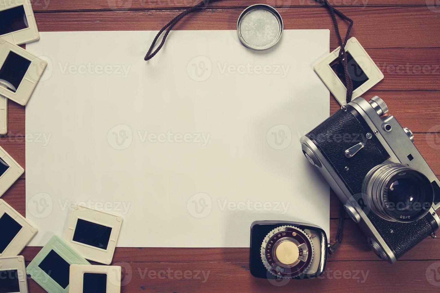 retro camera and some old photos on wooden table