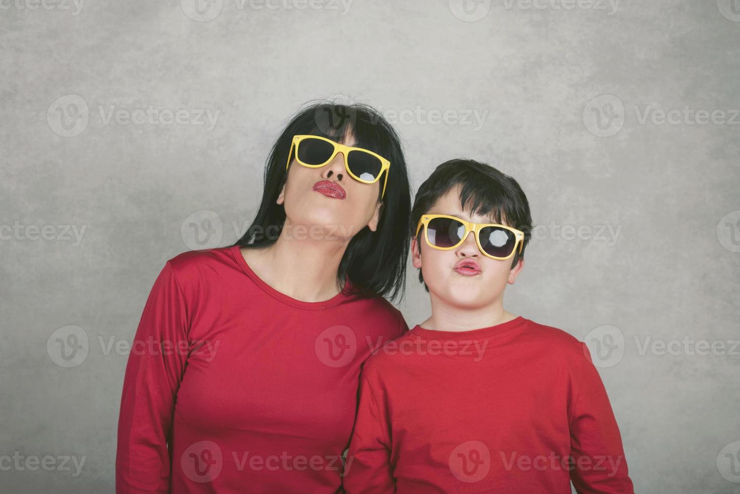 funny mother and son who give kisses photo