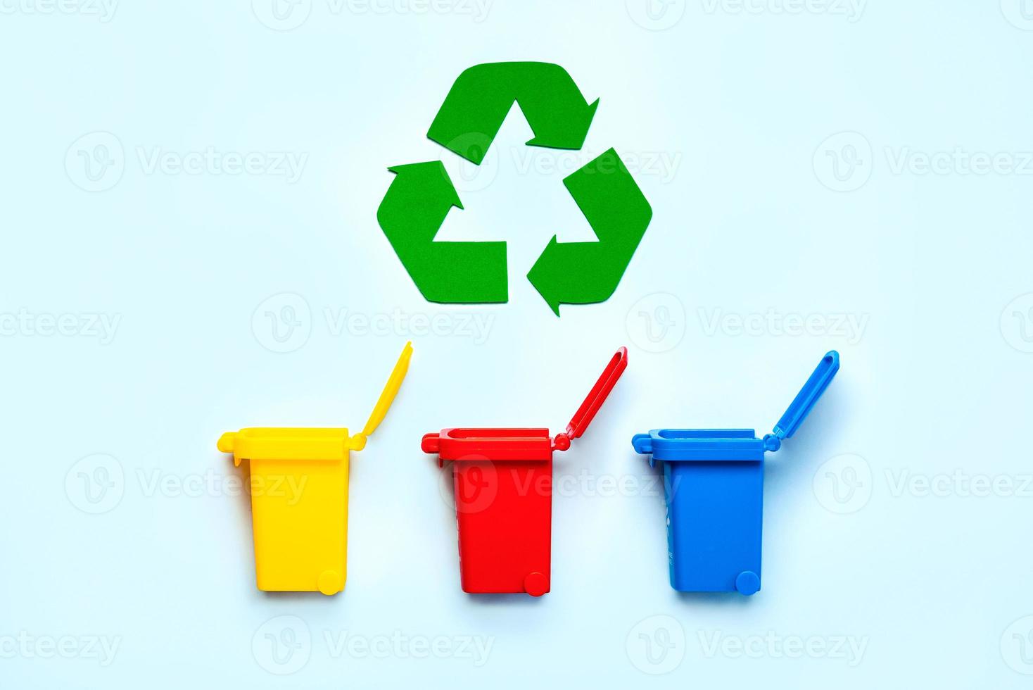 Yellow, red and blue recycle bins with recycle symbol. Recycling