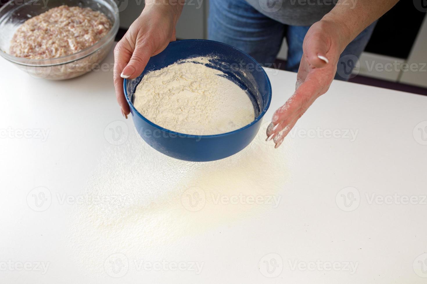 homemade dumplings in the kitchen without decorations. making dumplings with minced pork, beef and chicken photo