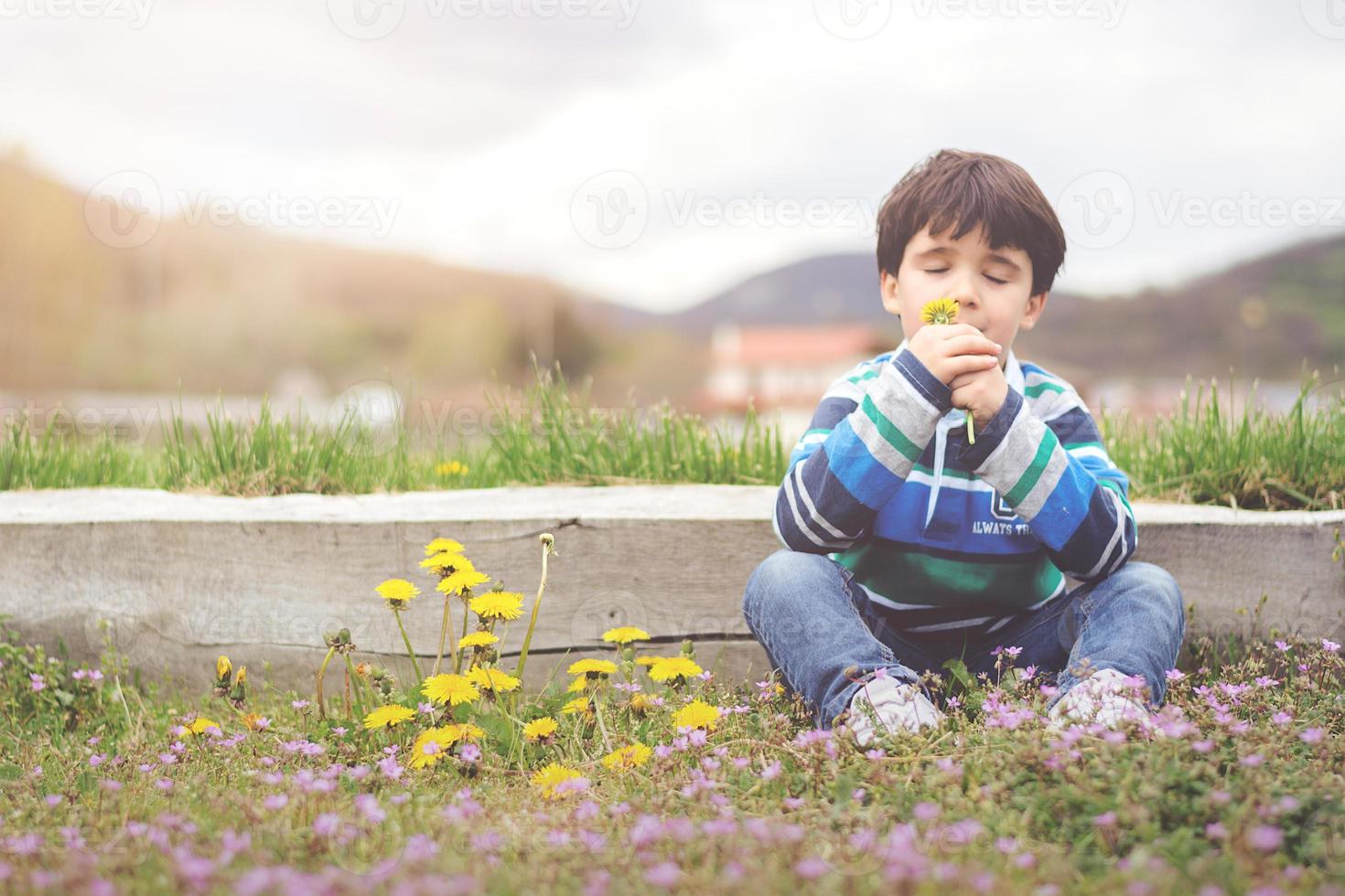 Happy child with flowers in spring photo