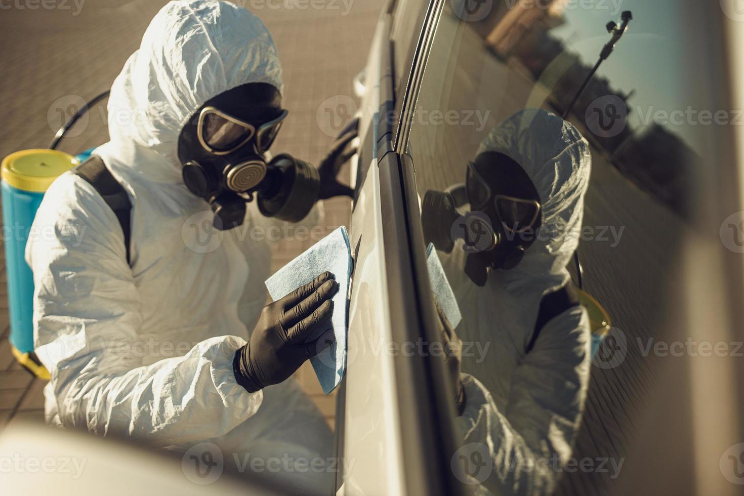 Cleaning and Disinfection of vehicles amid the coronavirus epidemic Car cleaning and disinfection Infection prevention and control of epidemic Protective suit and mask photo