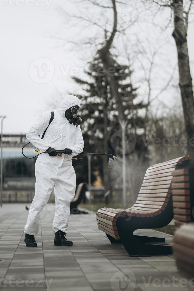 Cleaning and Disinfection at town complex amid the coronavirus epidemic Professional teams for disinfection efforts Infection prevention and control of epidemic Protective suit and mask photo