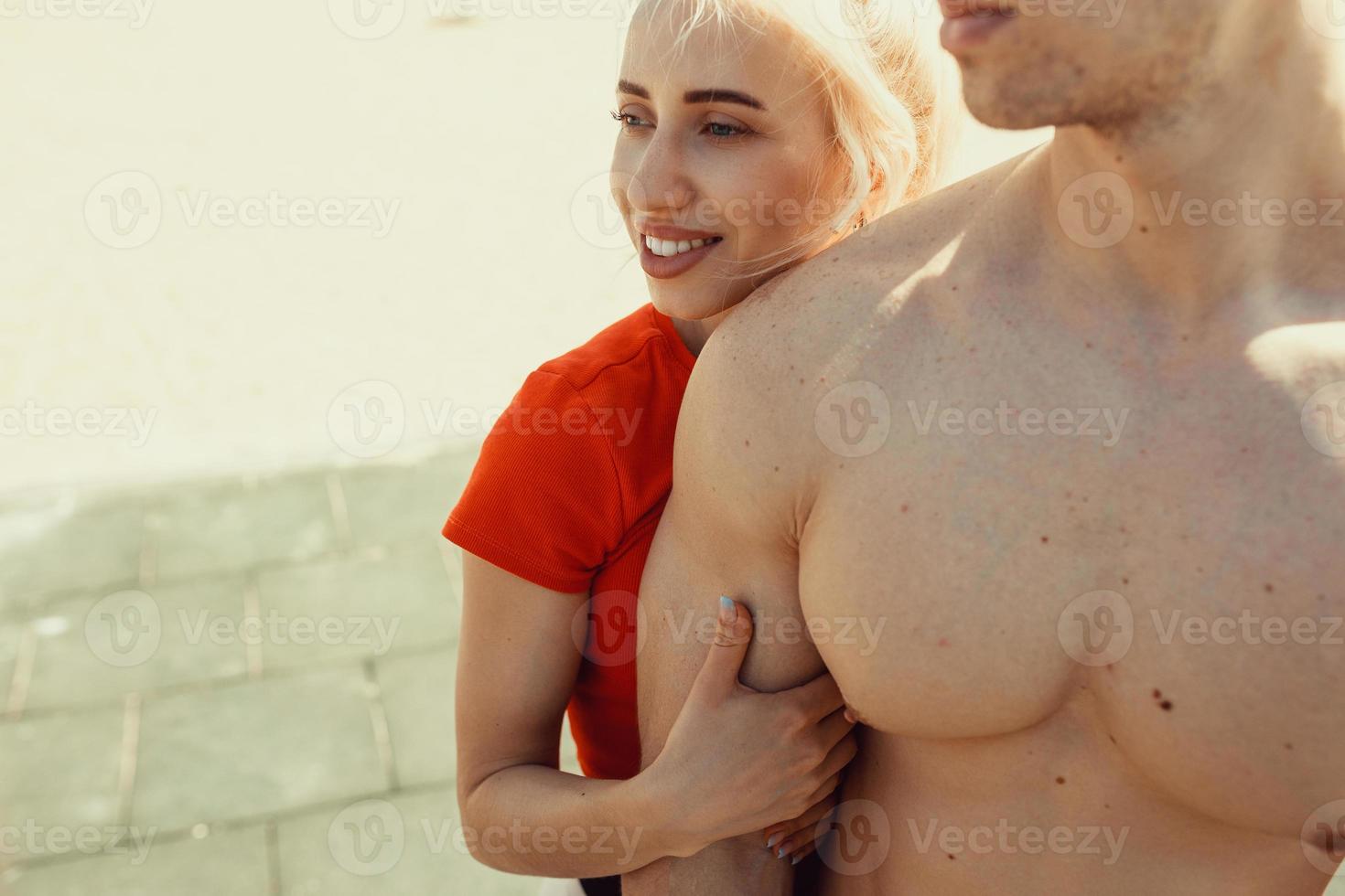 adorable blonde hugs her athletic boyfriend photo