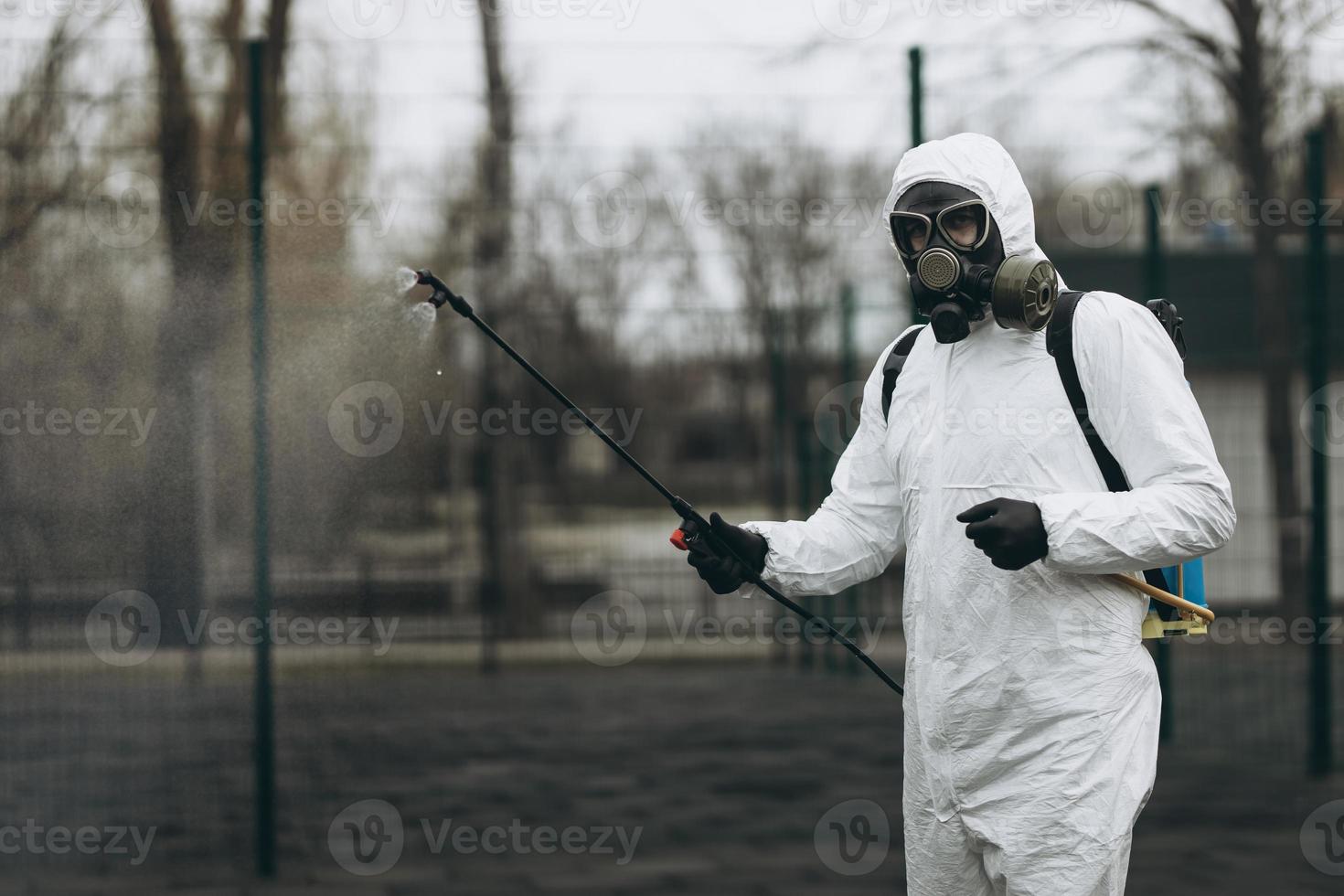 Cleaning and Disinfection at town complex amid the coronavirus epidemic Professional teams for disinfection efforts Infection prevention and control of epidemic Protective suit and mask photo