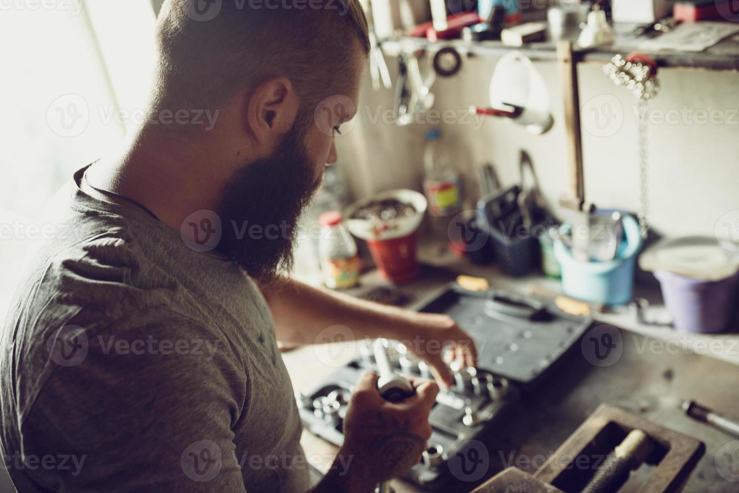 Handsome bearded man chooses tools for repair photo