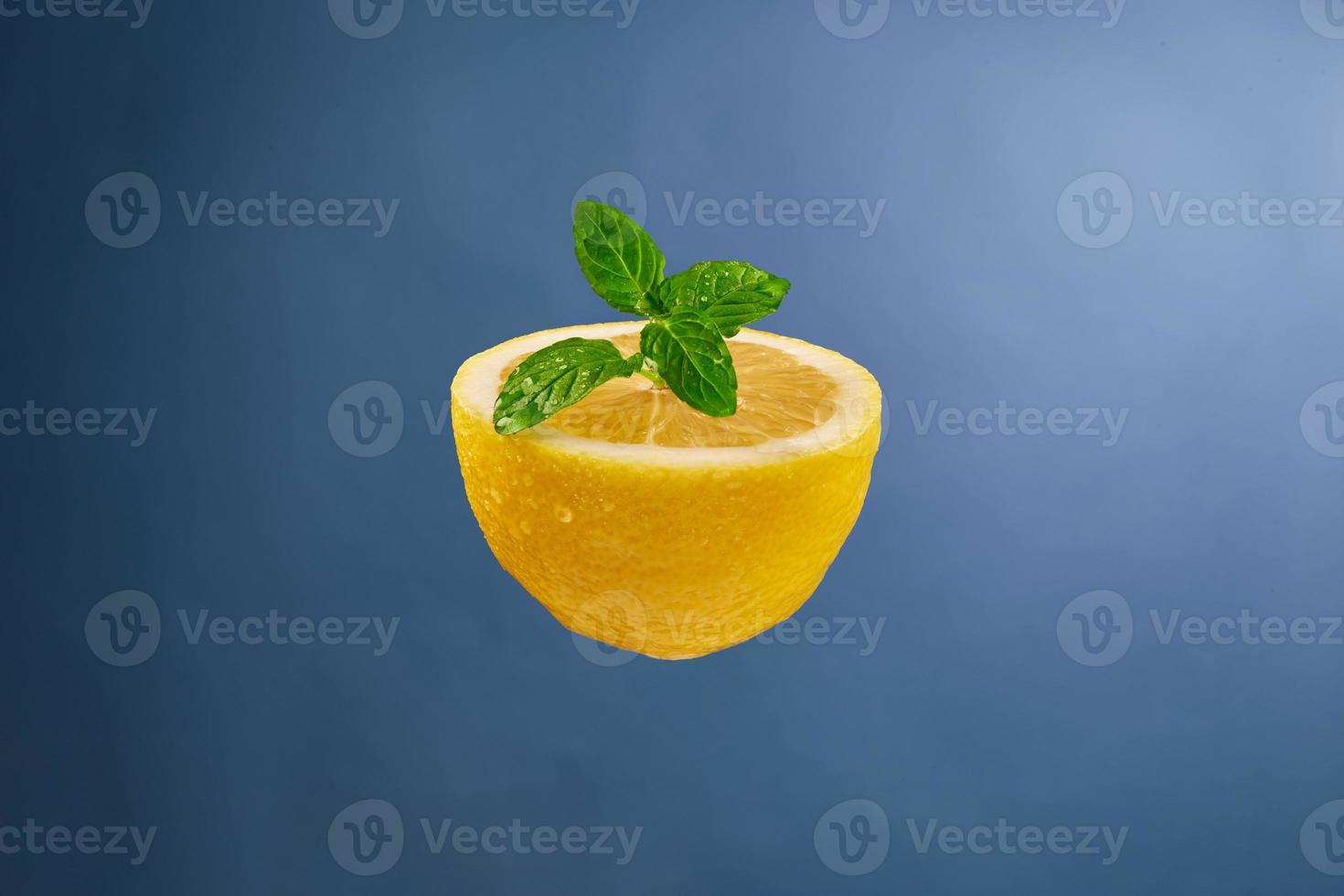 Half a lemon with mint on the background photo