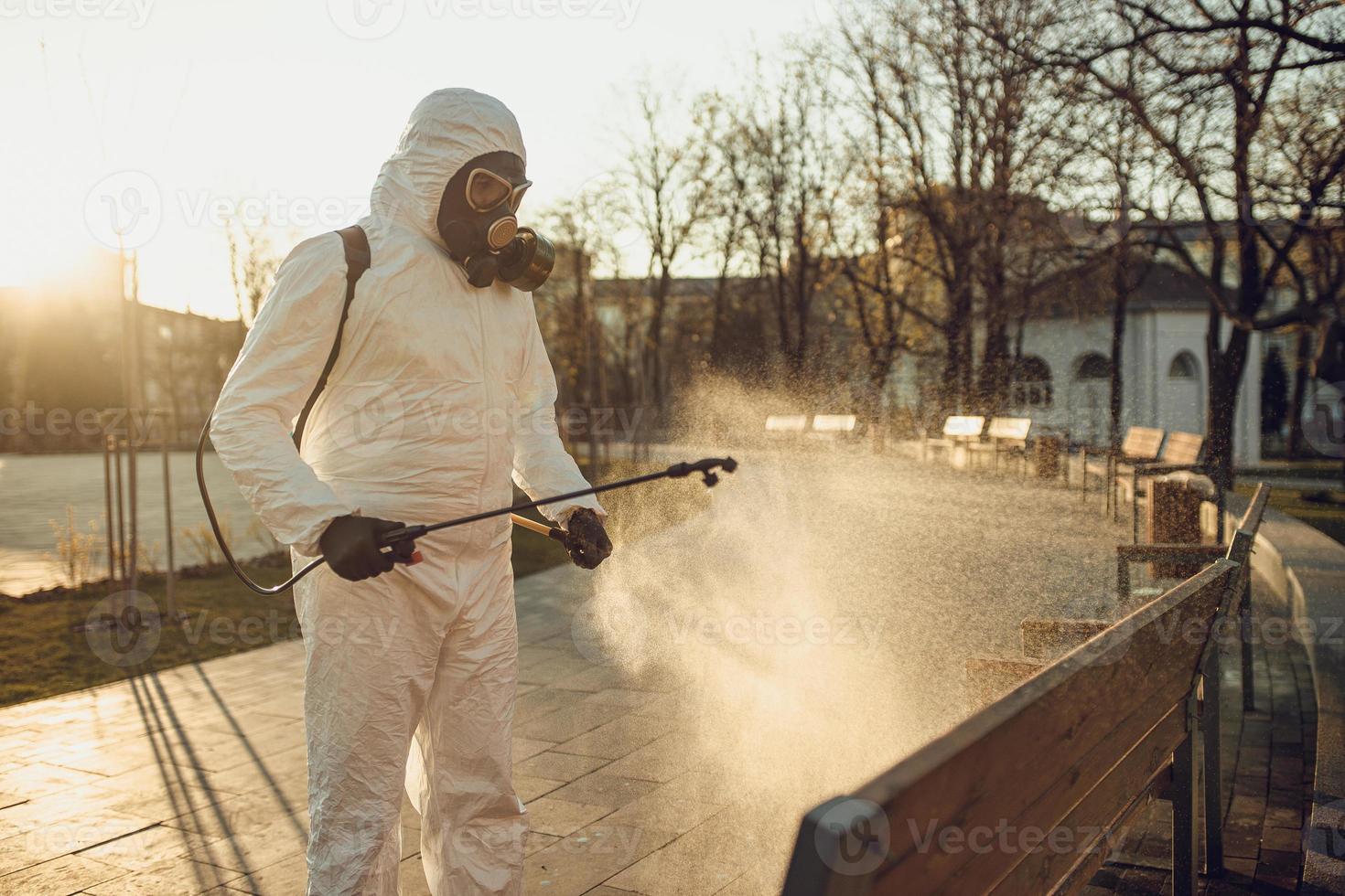 Cleaning and Disinfection on the playground in the sity complex amid the coronavirus epidemic Teams for disinfection efforts Infection prevention and control of epidemic Protective suit and mask photo