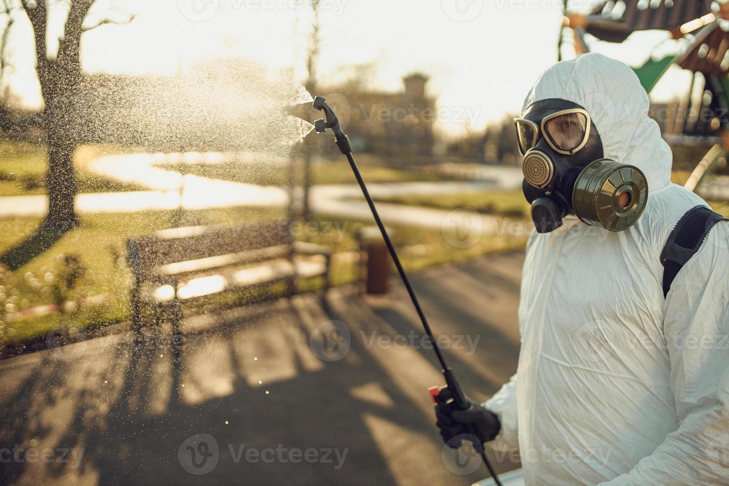 Cleaning and Disinfection on the playground in the sity complex amid the coronavirus epidemic Teams for disinfection efforts Infection prevention and control of epidemic Protective suit and mask photo