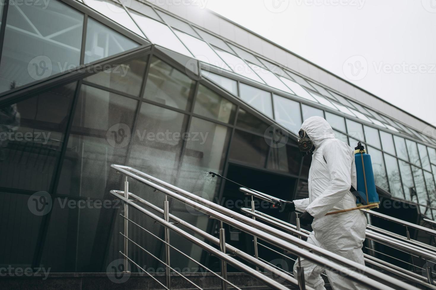 Cleaning and Disinfection at town complex amid the coronavirus epidemic Professional teams for disinfection efforts Infection prevention and control of epidemic Protective suit and mask photo