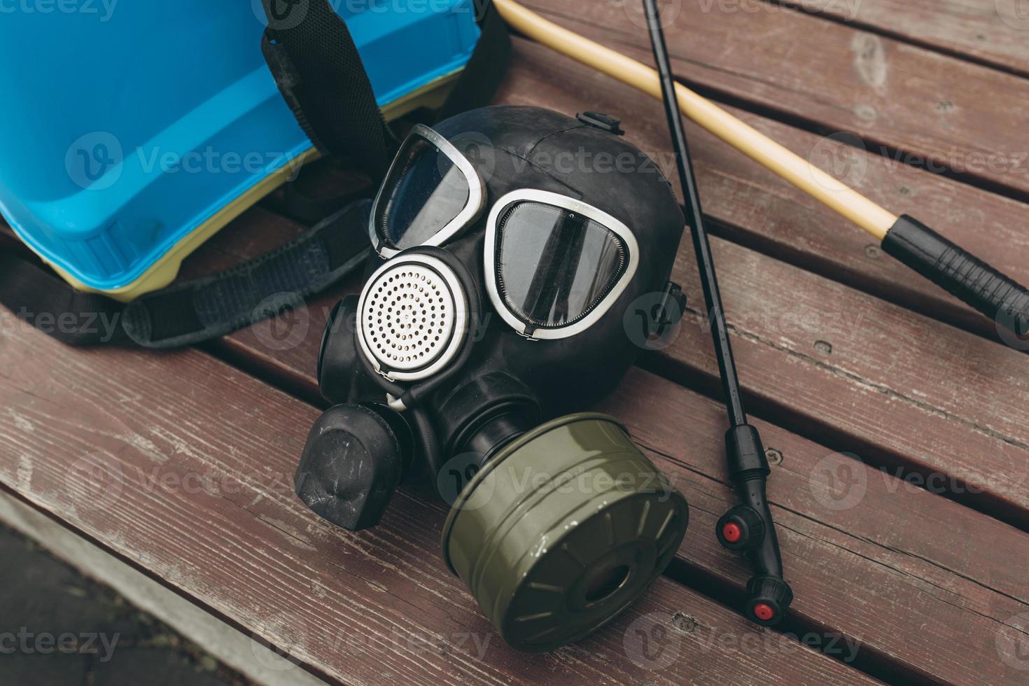A protective mask and knapsack for disinfection lie on a bench in the urban complex Protection and prevention of the coronavirus epidemic photo
