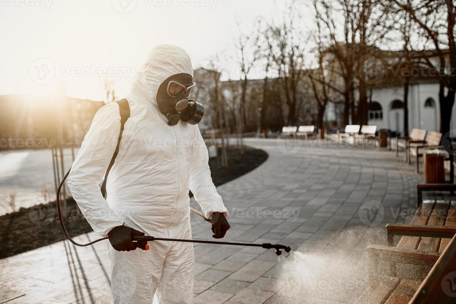 Cleaning and Disinfection on the playground in the sity complex amid the coronavirus epidemic Teams for disinfection efforts Infection prevention and control of epidemic Protective suit and mask photo