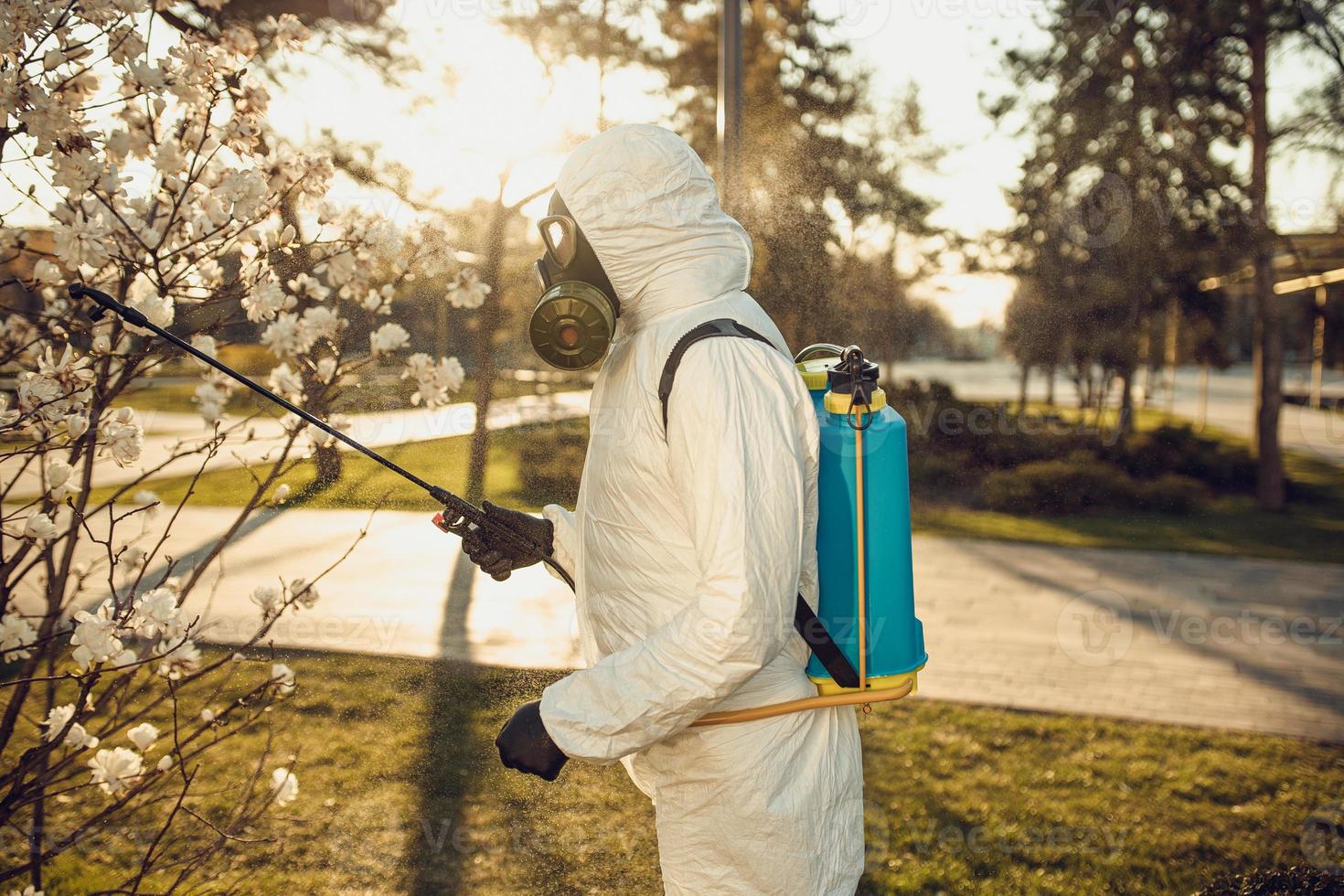 Cleaning and Disinfection on the playground in the sity complex amid the coronavirus epidemic Teams for disinfection efforts Infection prevention and control of epidemic Protective suit and mask photo