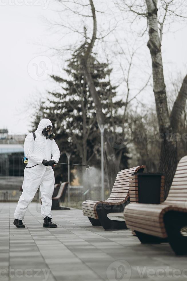 Cleaning and Disinfection at town complex amid the coronavirus epidemic Professional teams for disinfection efforts Infection prevention and control of epidemic Protective suit and mask photo