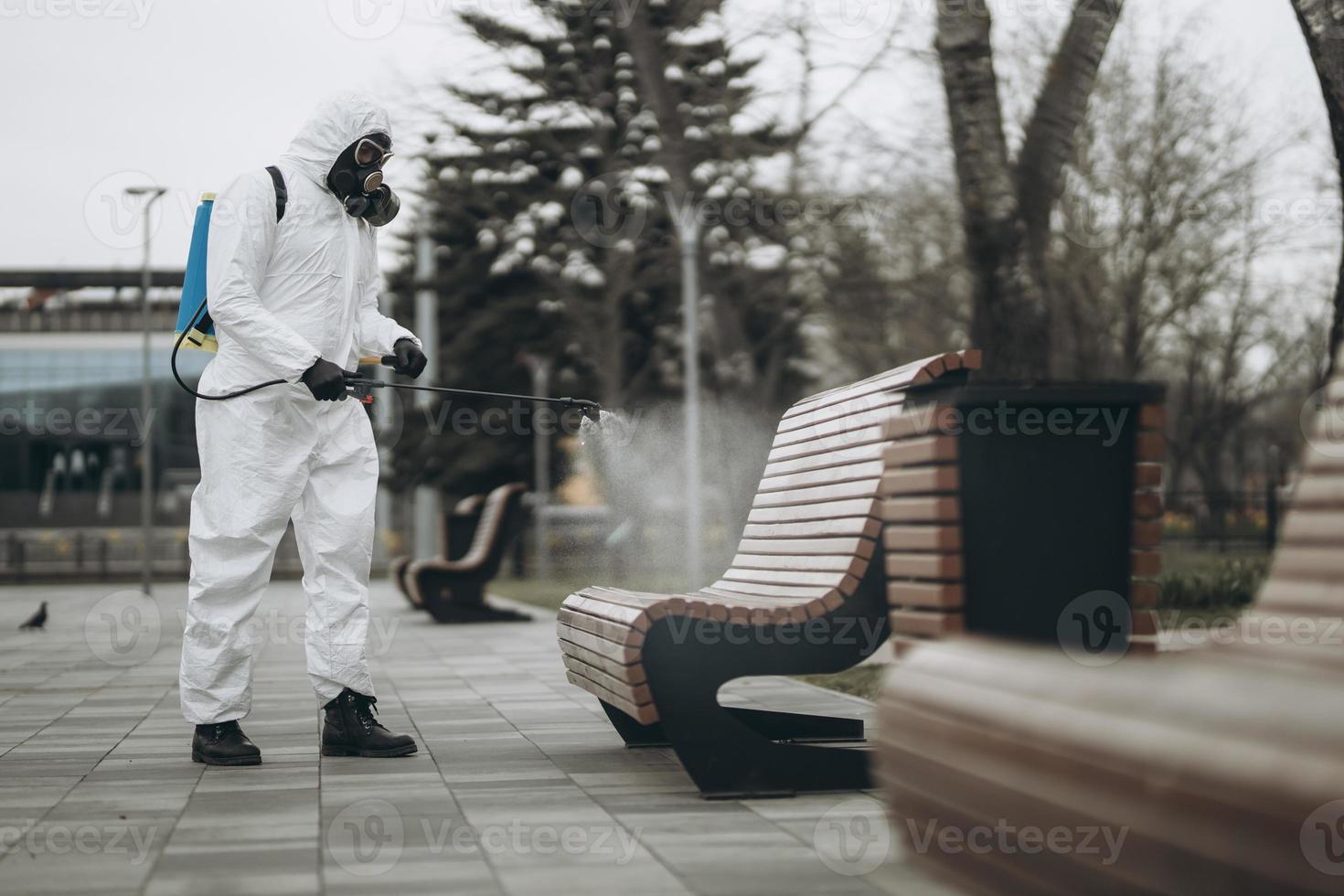 Cleaning and Disinfection at town complex amid the coronavirus epidemic Professional teams for disinfection efforts Infection prevention and control of epidemic Protective suit and mask photo